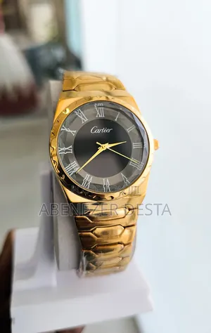 Gold-Tone Watch With a Black Face and Roman Numerals.