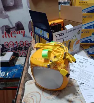Solar Vnex Lantern With an Integrated Led Light and a Yellow Body.