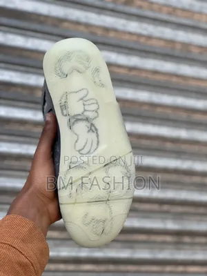 Air Jordan 4 Retro X Kaws "Cool Grey" Premium Sneakers