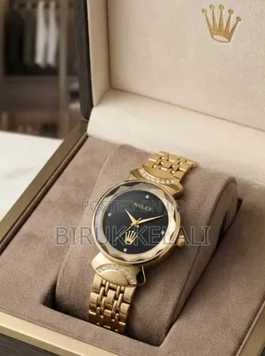 Gold-Toned Women's Watch Features a Black Dial, a Faceted Bezel