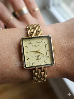Chanel-Style Watch With a Gold-Tone Square Face and a Link Bracelet.