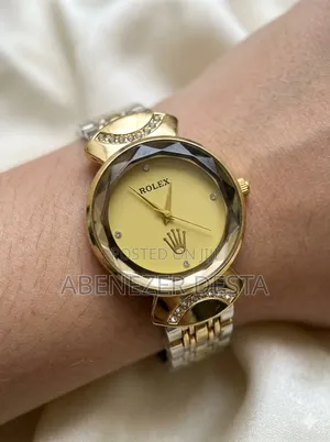 Gold-Toned Rolex Women's Luxury Watch With a Faceted Bezel.