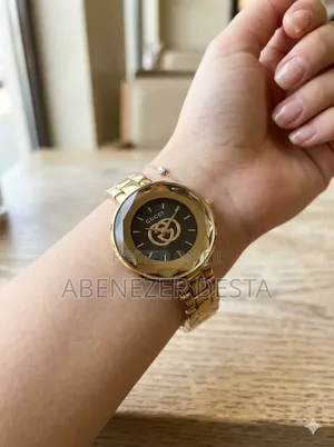 Gold-Tone Gucci Ladies' Watch With a Distinctive Bezel and Black Dial