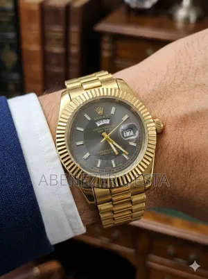 Day-Date Style Watch, Specifically a Stainless Steel Model With a Gold