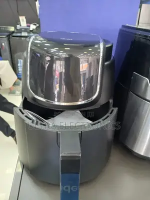 Midea Black Air Fryer With a Glossy Top Panel and Digital Controls.