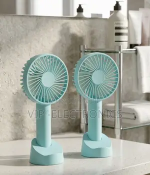 Twin Mint Green Handheld Fans on a Bathroom Vanity