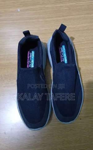Black Skechers Men's Slip-on Walking Sneakers.