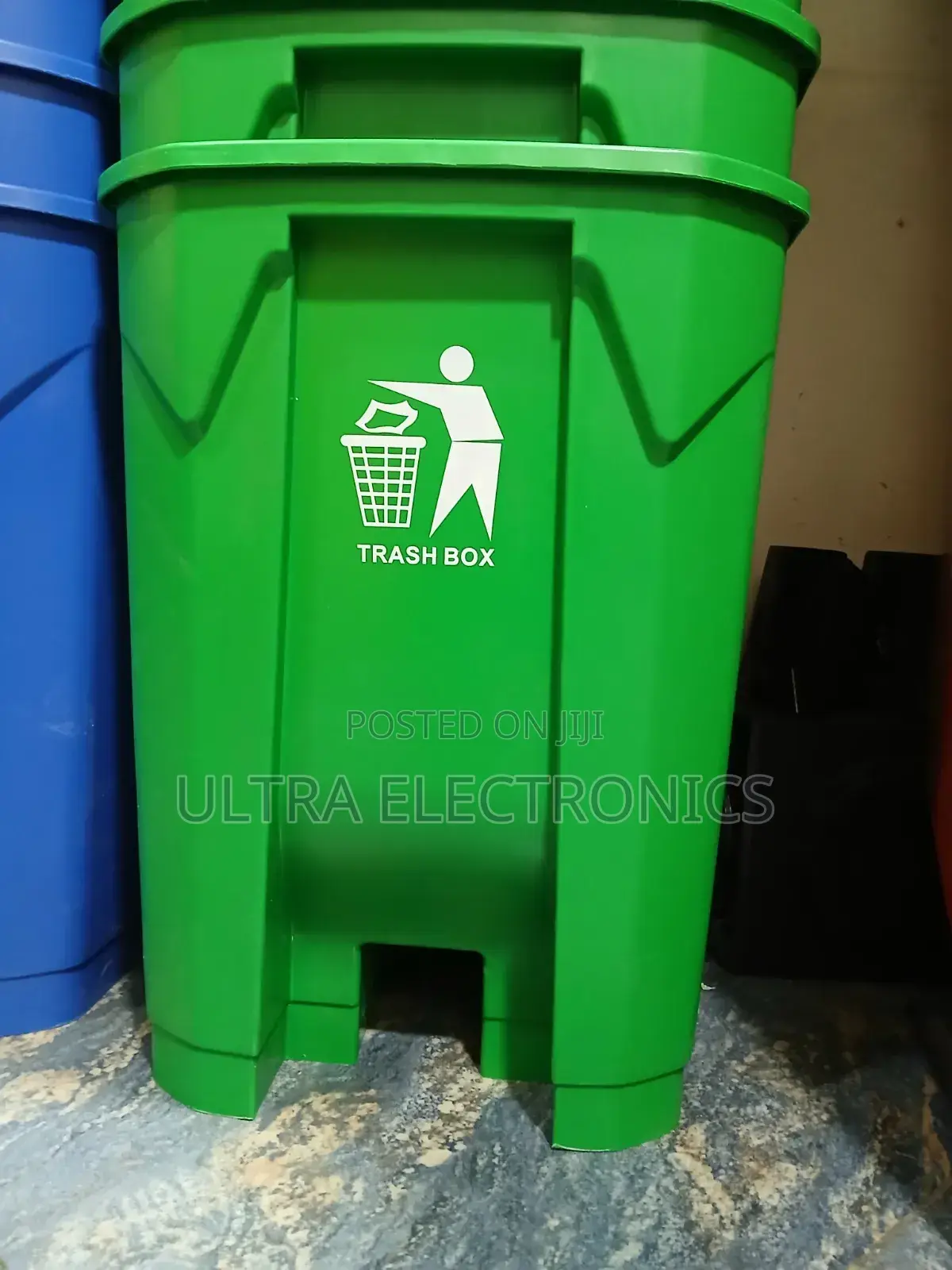 Green Plastic Step-on Trash Can Is Labeled "Trash Box". 50 Liter