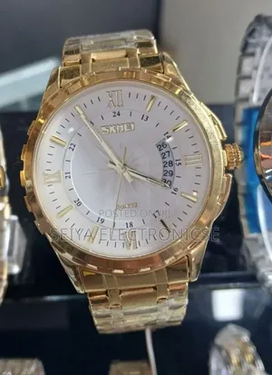 Skmei 9069 ♤ Features a Gold-Toned Stainless Steel ● Band