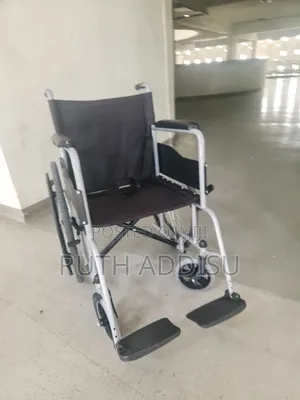 Manual Wheelchair Features a Lightweight Silver Frame and Durable Blac