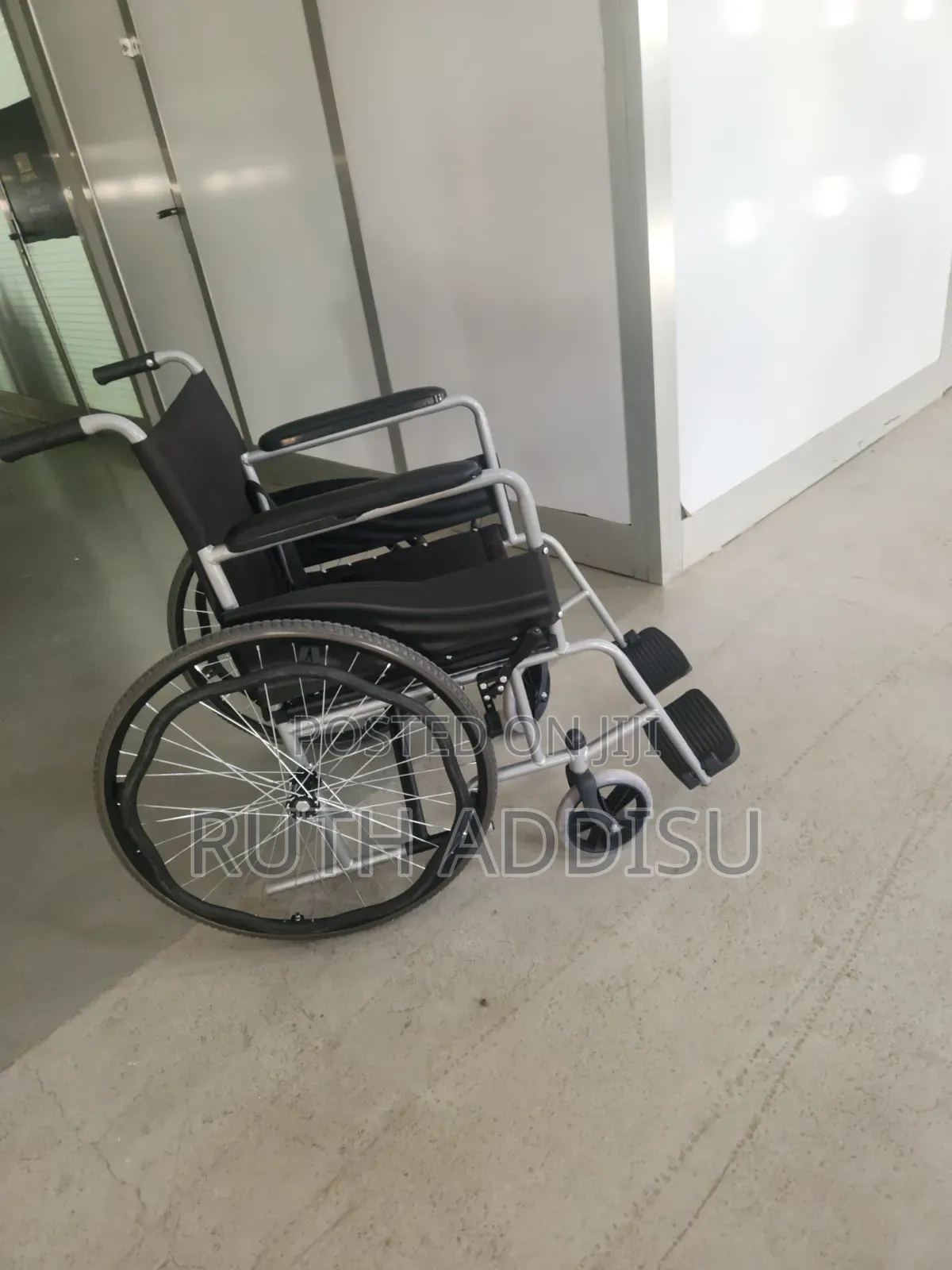 This Is a Foldable, Manual Wheelchair Featuring a Silver Metal Frame