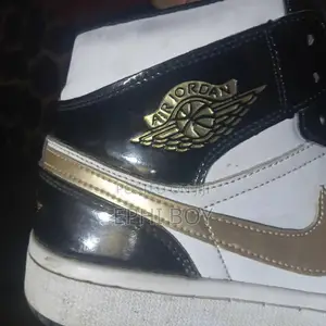 Nike Air Jordan 1 Mid in a Black/White/Metallic Gold