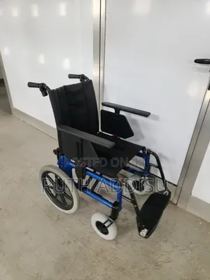Portable, Manual Travel Wheelchair Featuring a Black, Red Wheelchair