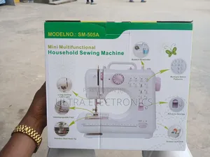 Mini Multifunctional Household Sewing Machine in Its Product Box.