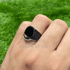 Sterling Silver Ring Featuring a Black Onyx Stone and Smaller Black