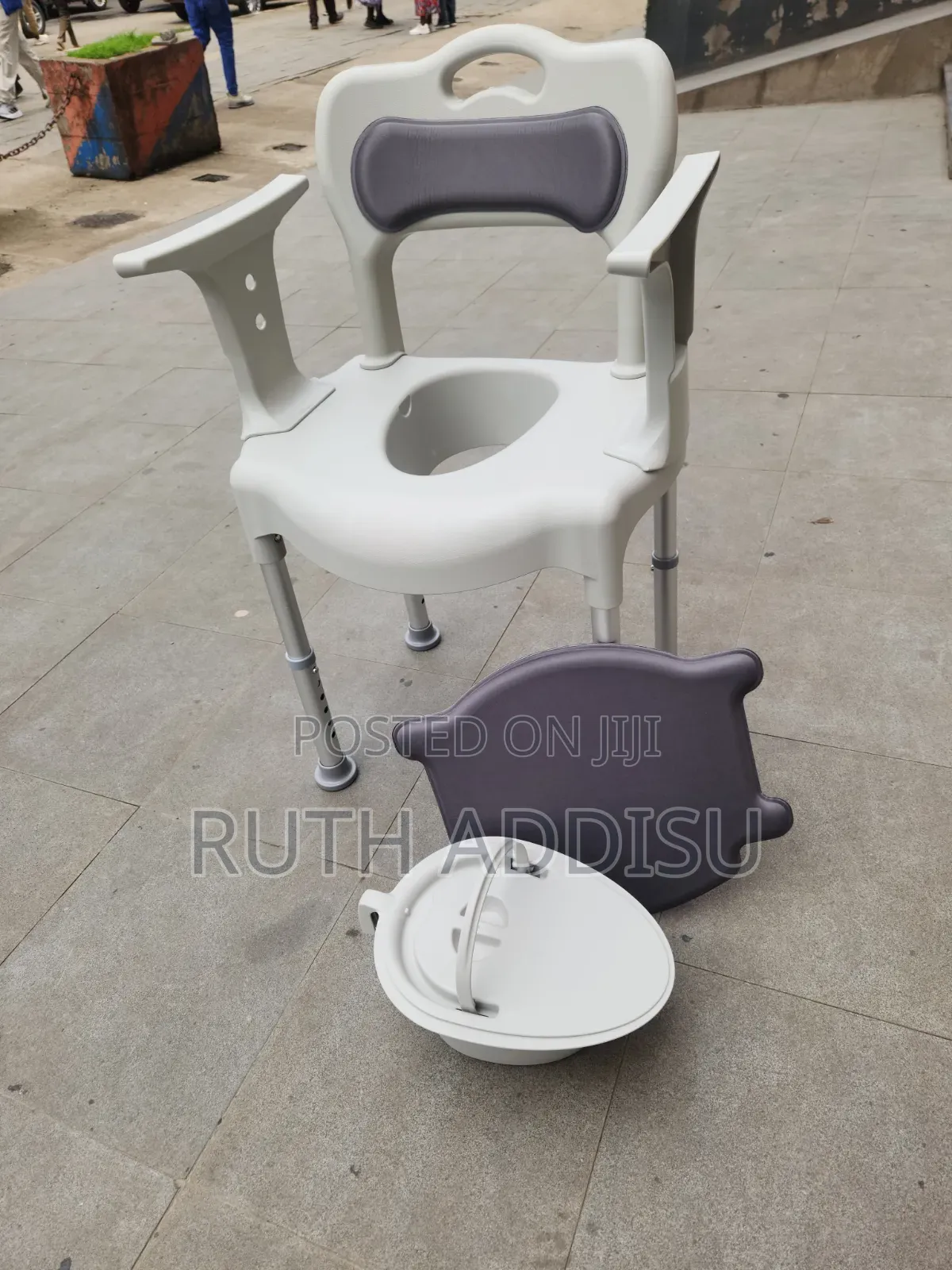 Appears to Be a 3-in-1 Bedside Commode Chair With a Grey Bucket