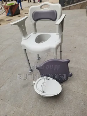 Appears to Be a 3-in-1 Bedside Commode Chair With a Grey Bucket