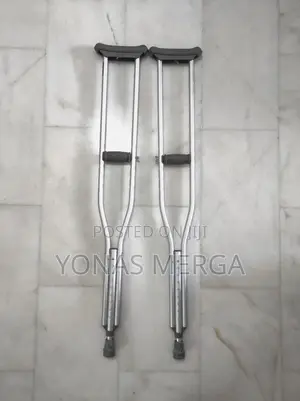 Auxiliary Crutch Pair to Patient Post-Surgery/Injury in Legs