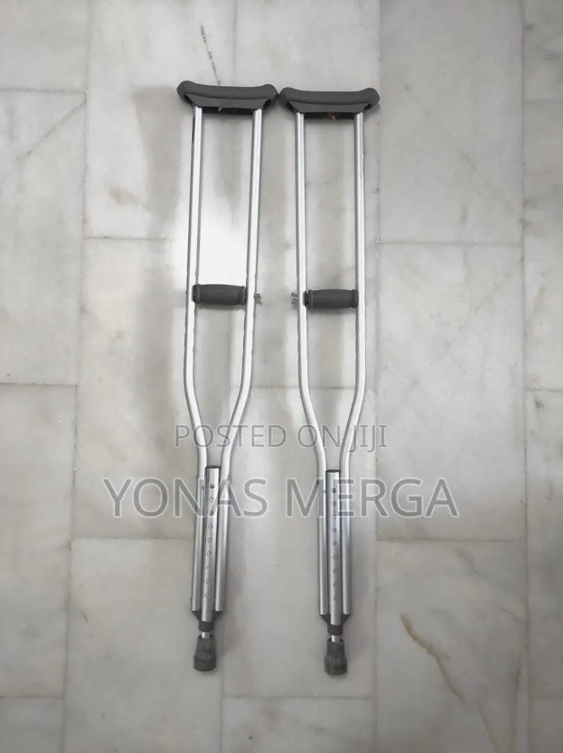 Auxiliary Crutch Pair to Patient Post-Surgery/Injury in Legs