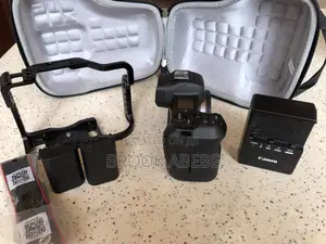 Canon R With Cage and Extras on Hand