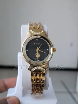 Gold-Toned Women's Watch With a Black Face and Crystal Accents.