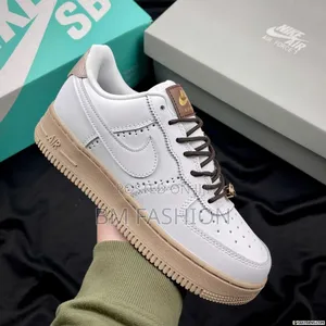 Nike Air Force 1 '07 Sneakers in a White and Tan Colorway.